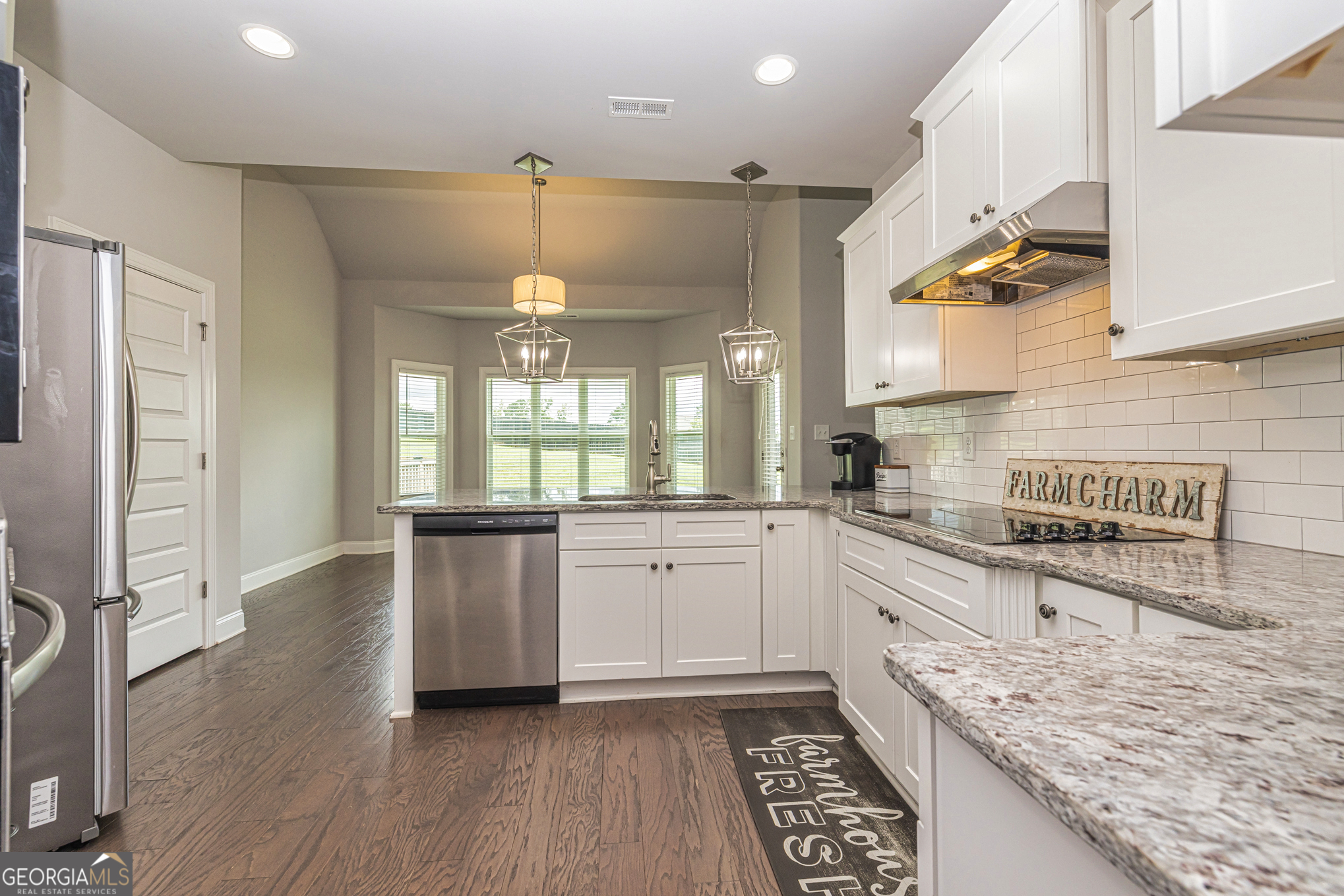 941 Highway 16 Newnan, GA 30263 - Photo 14 of 43 a kitchen with granite countertop a stove a sink and a refrigerator
