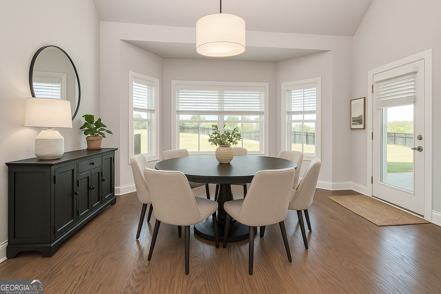 941 Highway 16 Newnan, GA 30263 - Photo 15 of 43 a dining room with furniture a chandelier and wooden floor