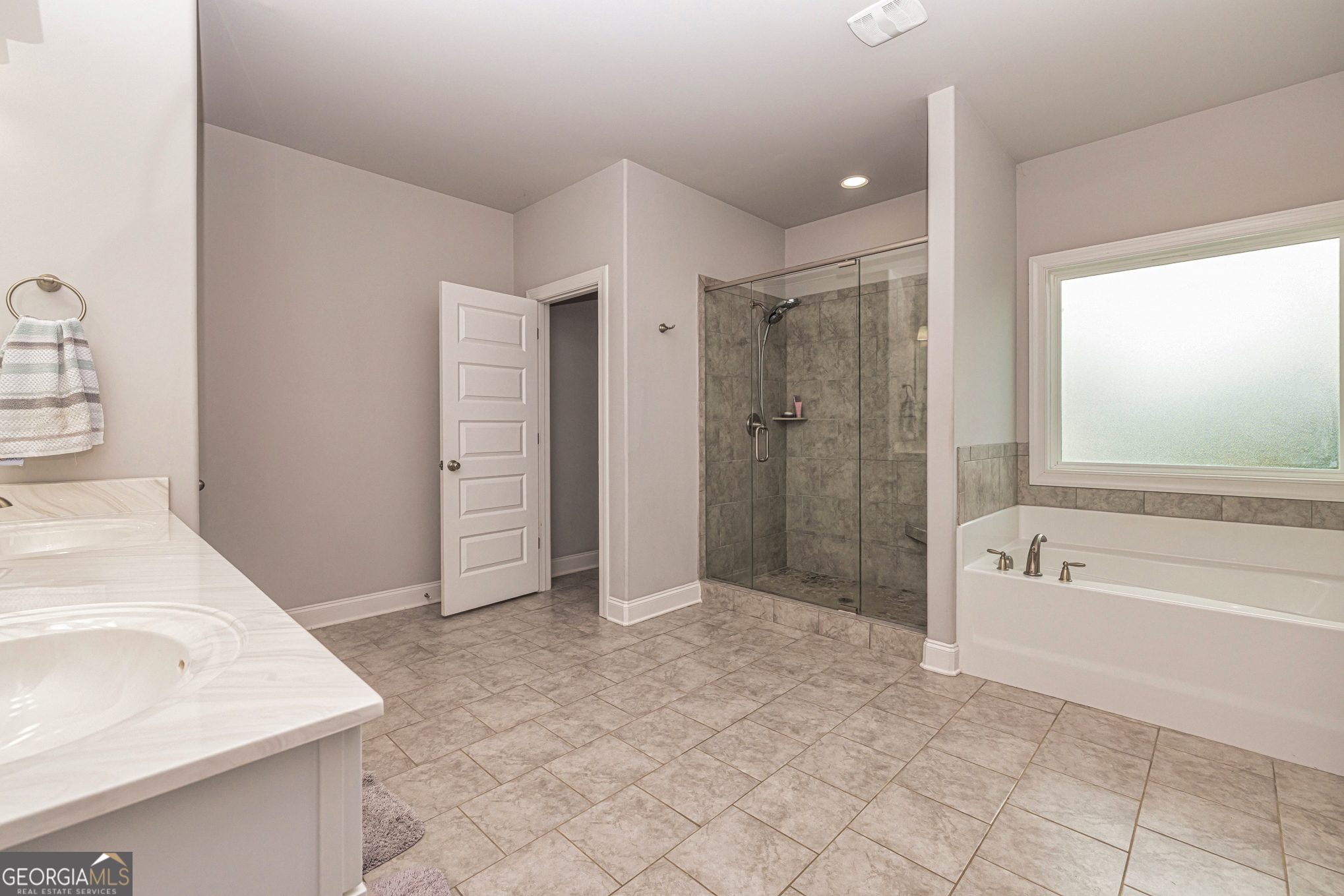 941 Highway 16 Newnan, GA 30263 - Photo 20 of 43 a bathroom with a tub sink and shower