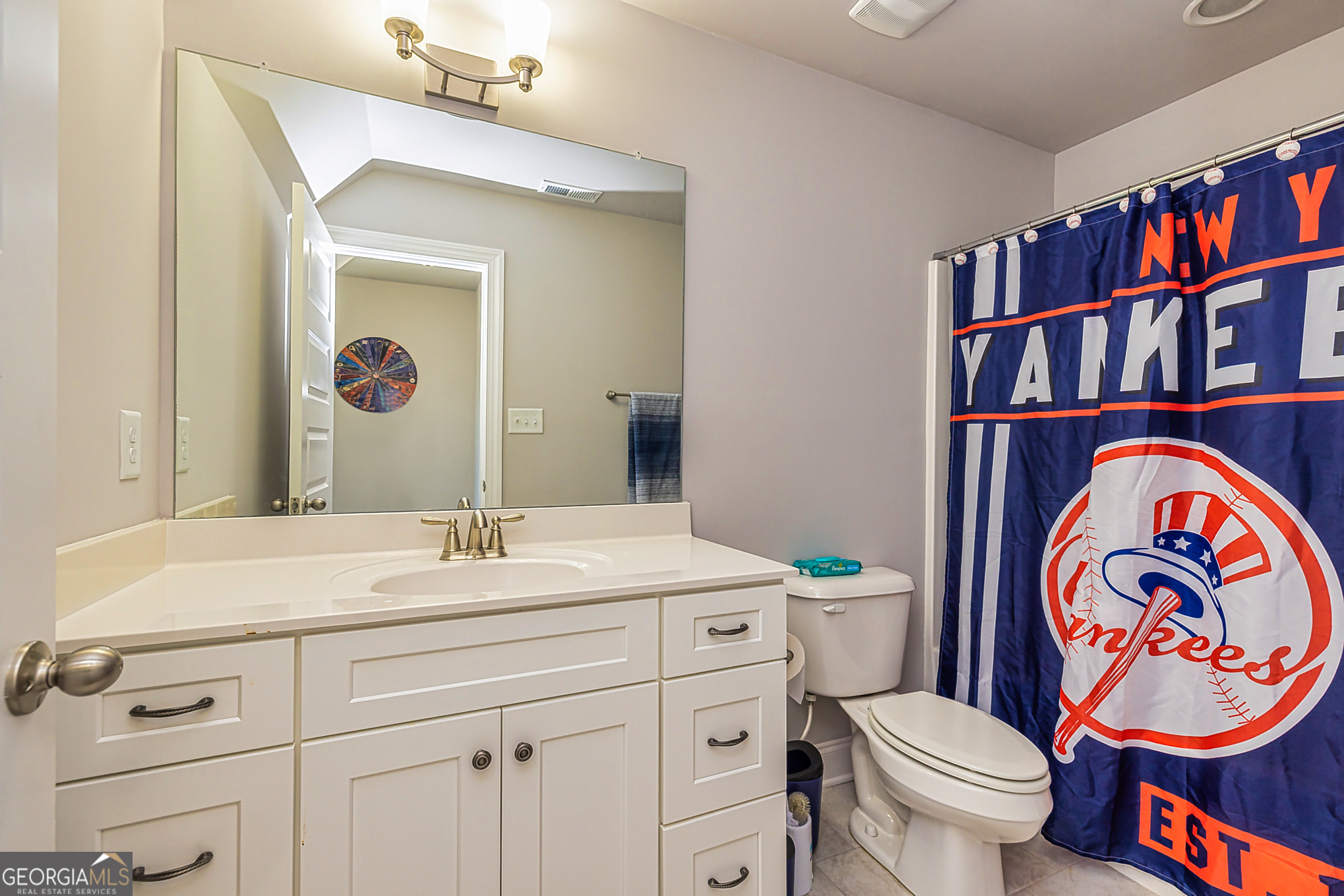 941 Highway 16 Newnan, GA 30263 - Photo 27 of 43 a bathroom with a sink a vanity and a toilet