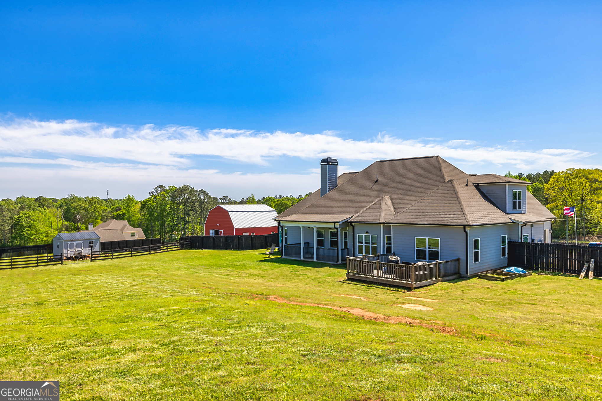 941 Highway 16 Newnan, GA 30263 - Photo 31 of 43 a view of a swimming pool with lawn chairs under an umbrella