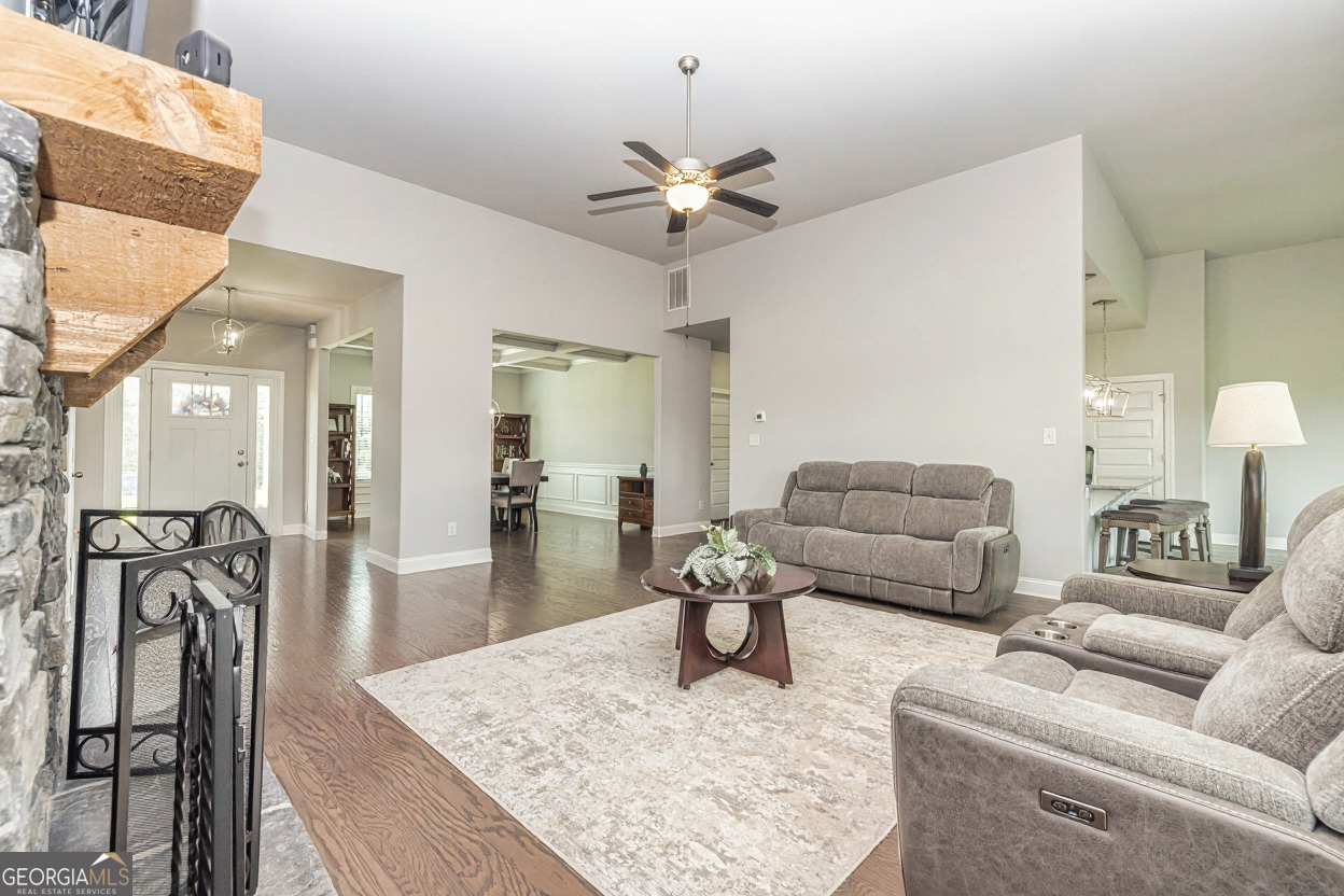 941 Highway 16 Newnan, GA 30263 - Photo 7 of 43 a living room with furniture and a chandelier