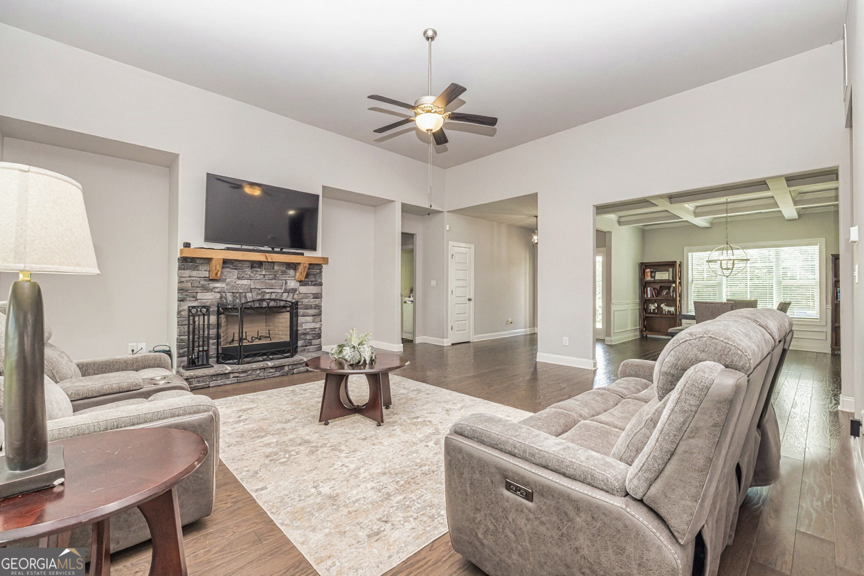 941 Highway 16 Newnan, GA 30263 - Photo 8 of 43 a living room with furniture a fireplace and a flat screen tv