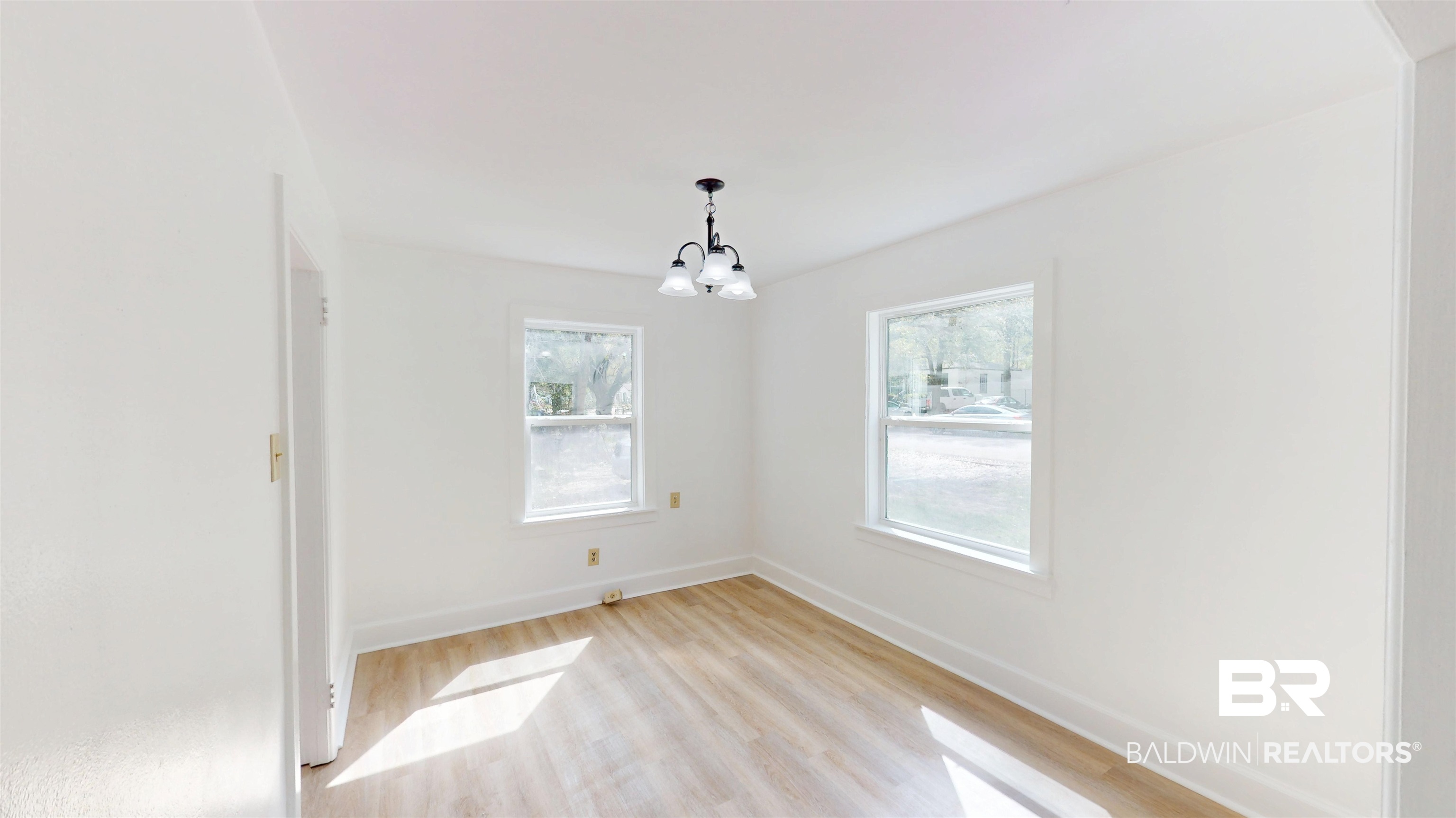 606 Shady Oak Drive Mobile, AL 36608 - Photo 5 of 14 Unfurnished dining area with light wood finished floors and a chandelier