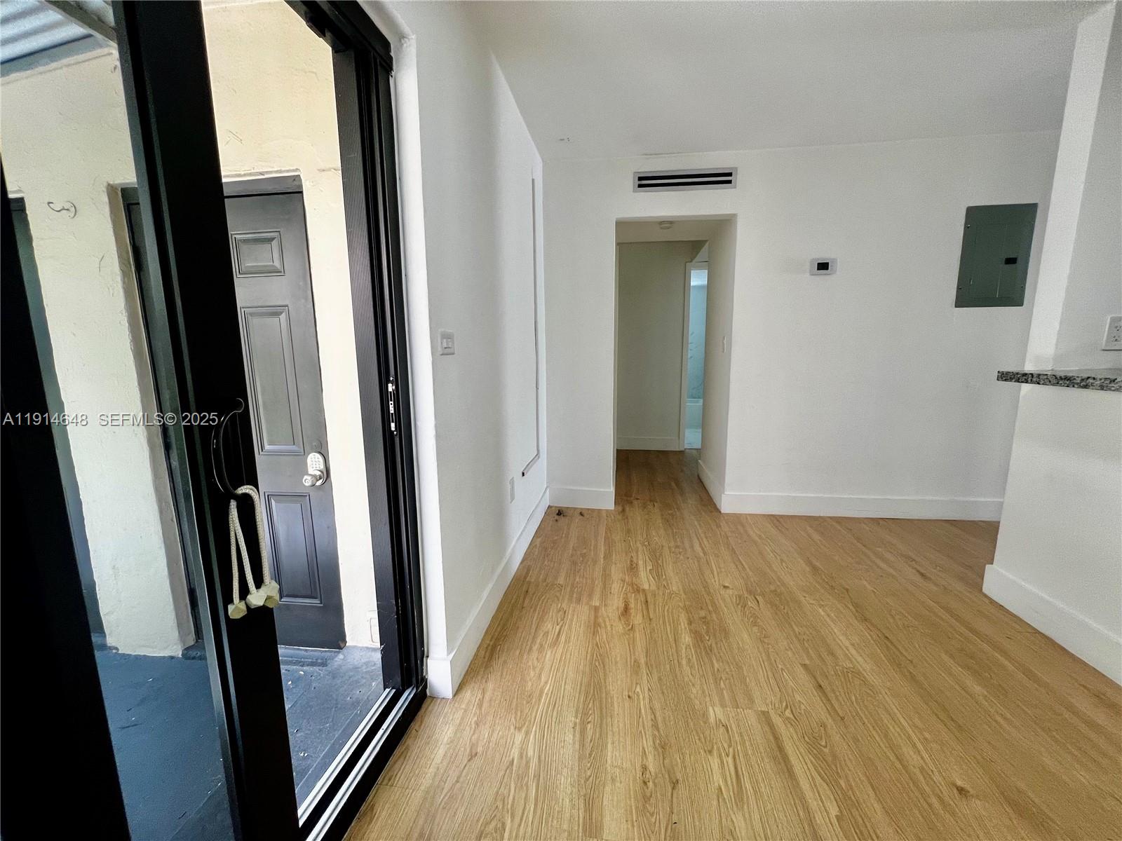 3520 Southwest 25th Street Miami, FL 33133 - Photo 29 of 43 a view of a hallway with wooden floor