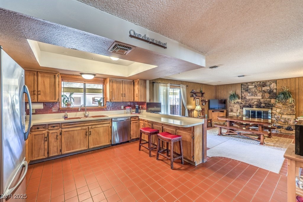 10615 Rancho Destino Road Las Vegas, NV 89183 - Photo 15 of 53 Kitchen with a peninsula, plenty of natural light, appliances with stainless steel finishes, and a sink
