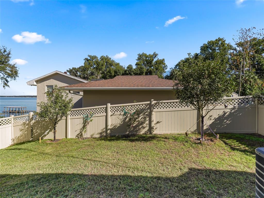 12943 Southeast Sunset Harbor Road Weirsdale, FL 32195 - Photo 50 of 87 a view of a house with a yard