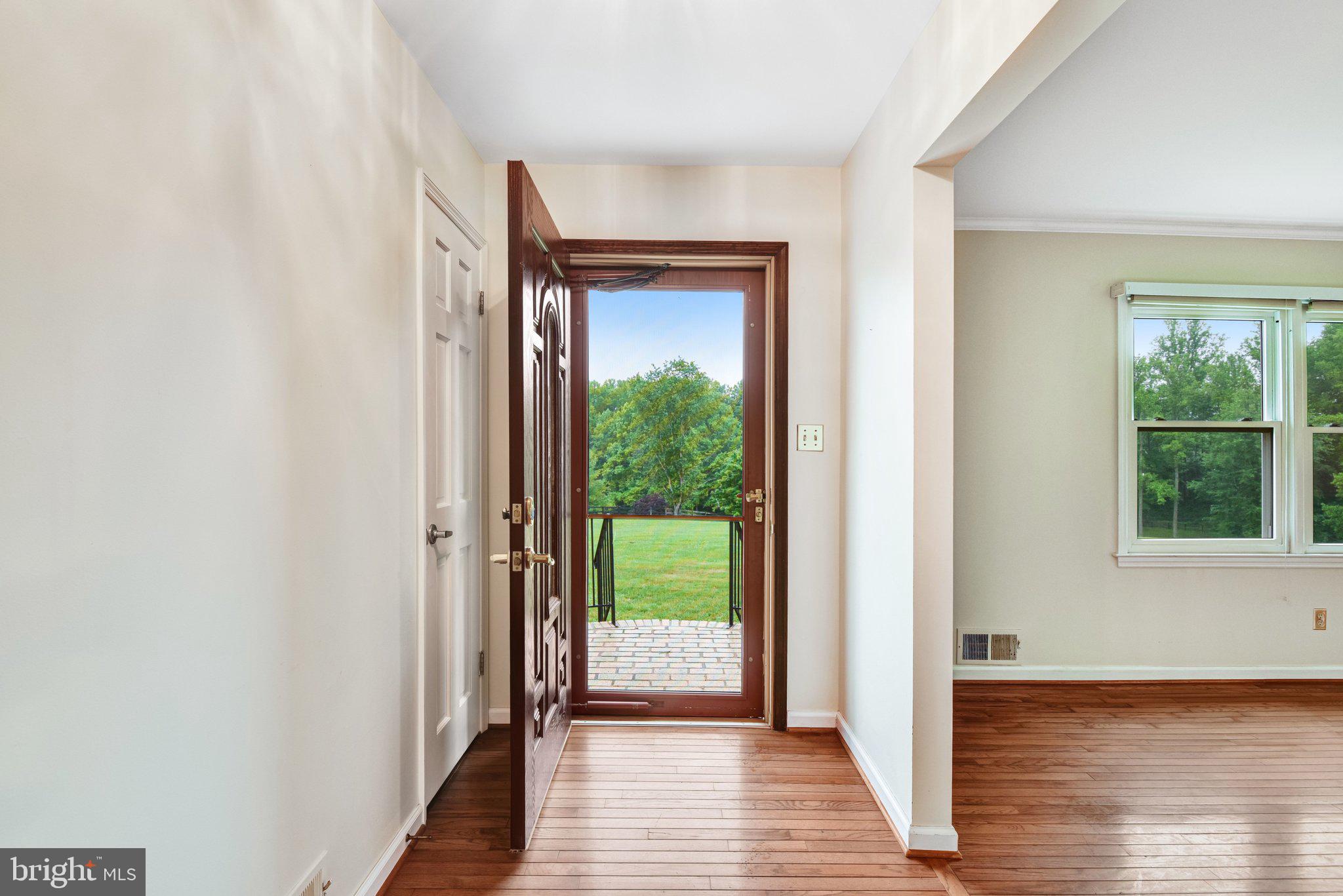7961 Leeds Manor Road Marshall, VA 20115 - Photo 5 of 40 a view of a hallway with wooden floor stairs and a bathroom
