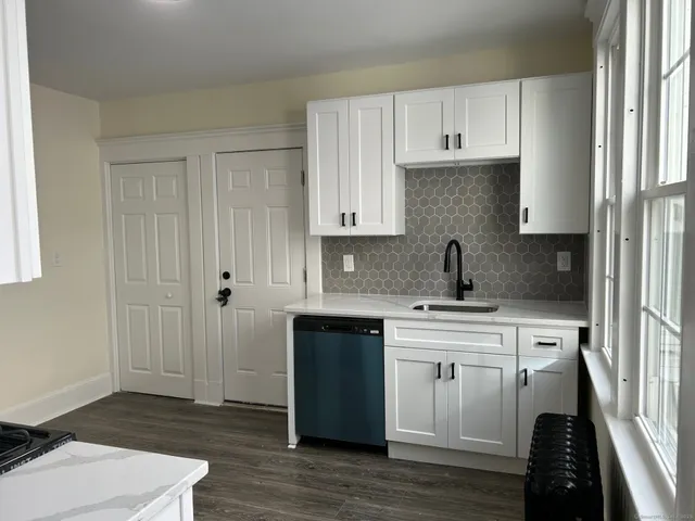 a kitchen with a sink stove and cabinets