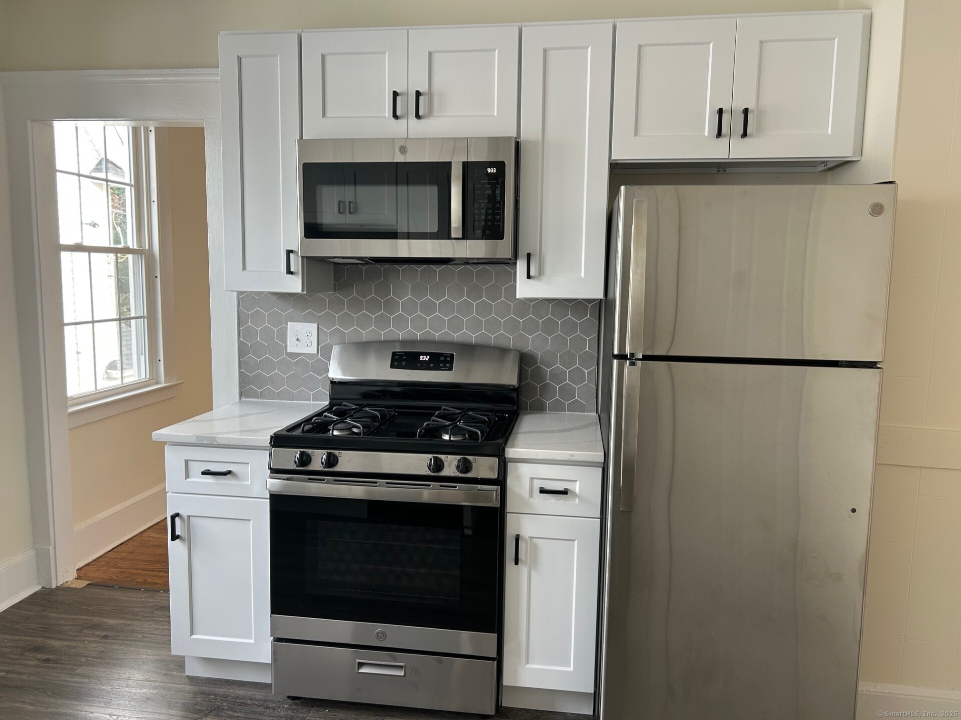 592 3rd Avenue West Haven, CT 06516 - Photo 5 of 14 a kitchen with stainless steel appliances a stove a microwave and refrigerator