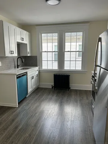 a kitchen with wooden floors and sink