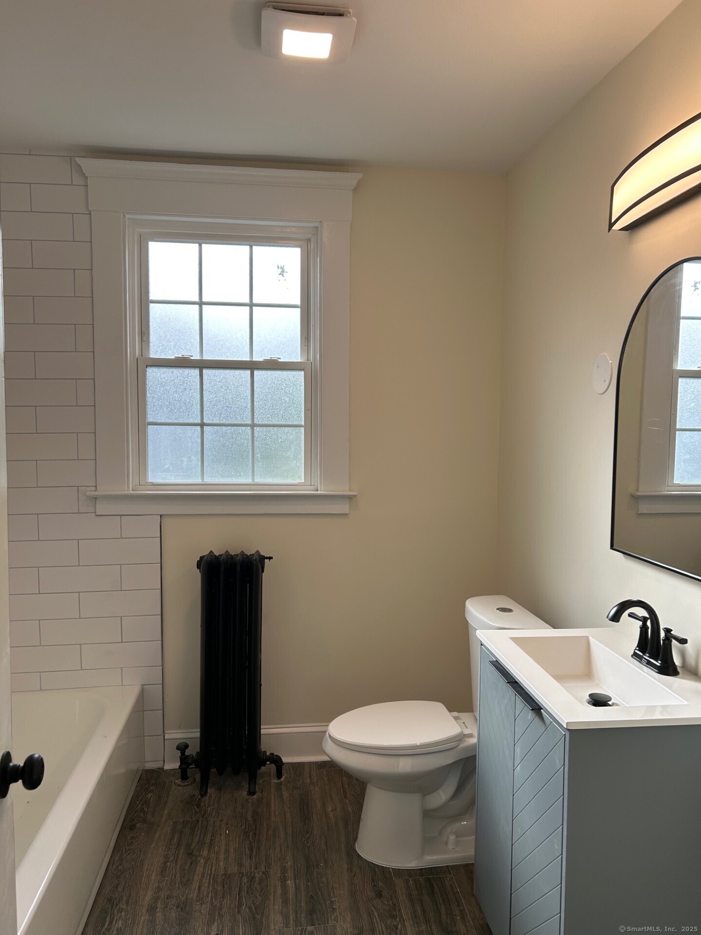592 3rd Avenue West Haven, CT 06516 - Photo 7 of 14 a bathroom with a toilet sink and mirror