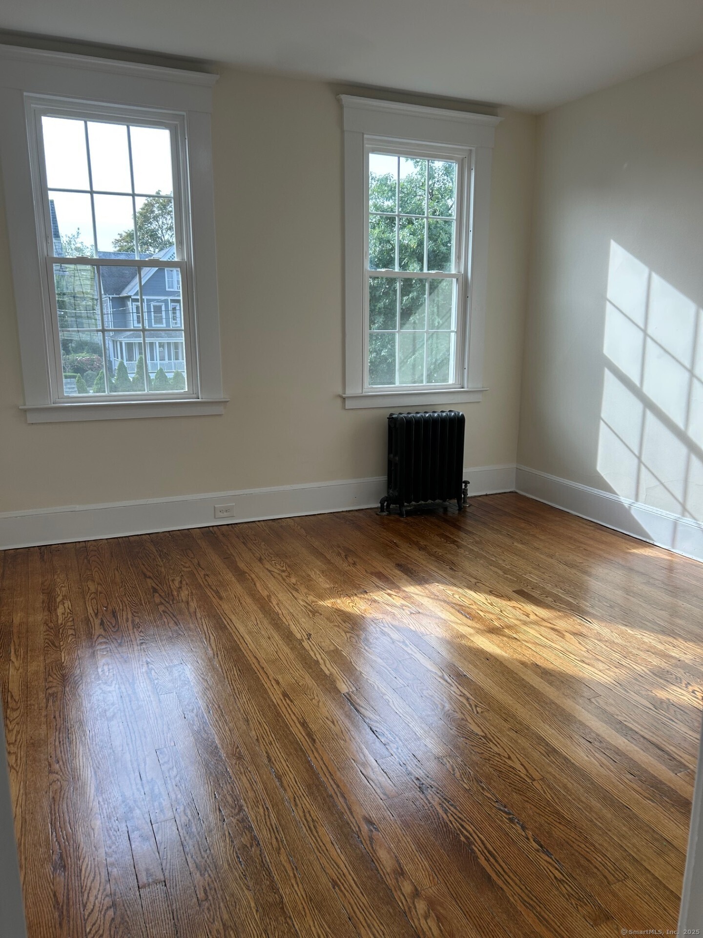 592 3rd Avenue West Haven, CT 06516 - Photo 8 of 14 an empty room with wooden floor and windows