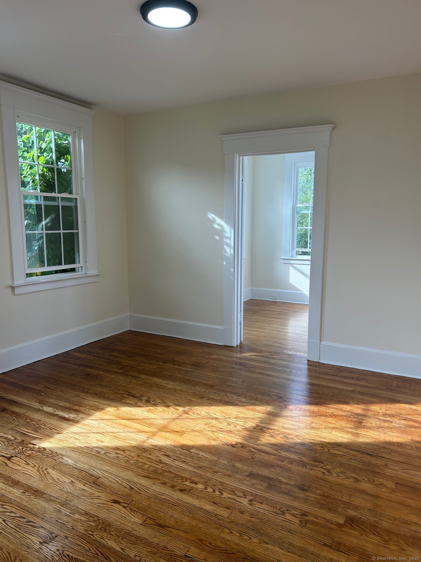 592 3rd Avenue West Haven, CT 06516 - Photo 9 of 14 a view of empty room with wooden floor and fan