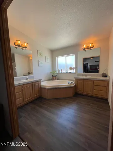 a kitchen with a sink a window and chairs