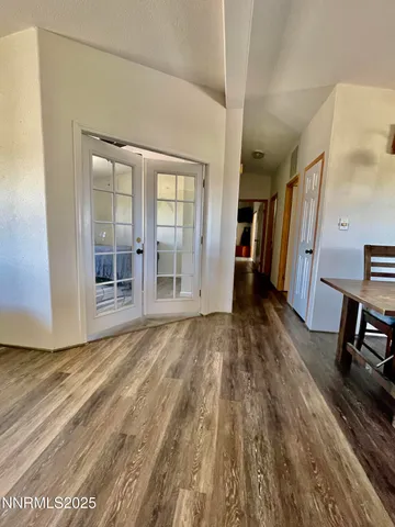 a view of empty room with wooden floor and stairs