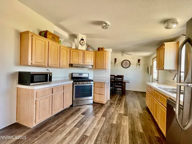 a kitchen with stainless steel appliances a stove a sink and a refrigerator