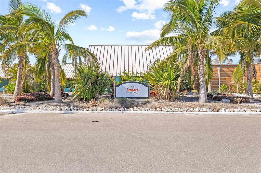 2312 West Shell Point Road Ruskin, FL 33570 - Photo 31 of 43 a couple of palm trees in front of yellow house