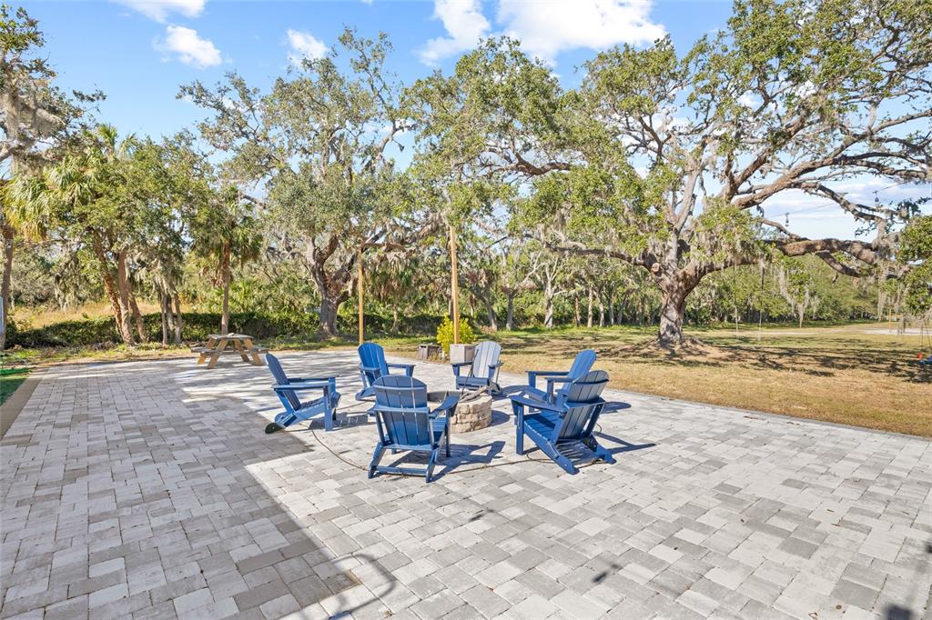 2312 West Shell Point Road Ruskin, FL 33570 - Photo 9 of 43 a backyard of a house with table and chairs