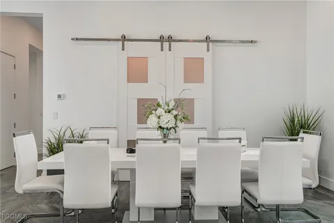 a large white bedroom with a large bed and a large window