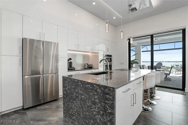 a kitchen with granite countertop a sink and stove