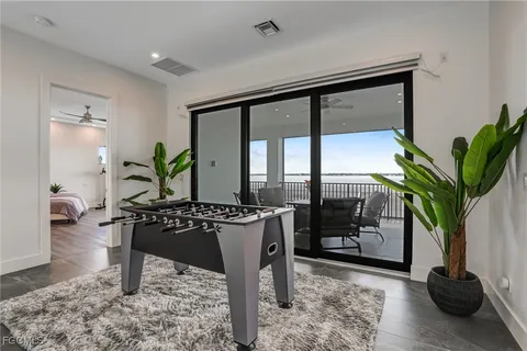 a living room with furniture potted plant and a wooden floor
