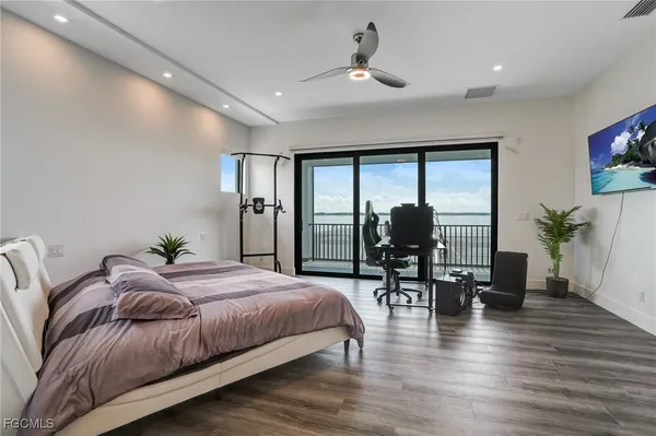 a living room with furniture potted plant and a wooden floor