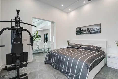 a bedroom with a bed and a painting on the wall