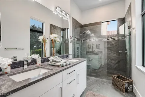 a bedroom with a large bed and a flat tv screen on dresser