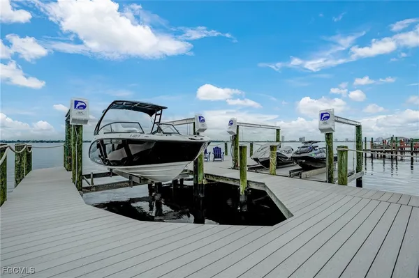 an aerial view of a house with a yard and lake view