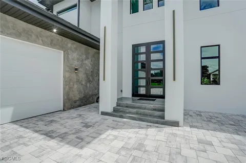 a large white room with mirror and windows