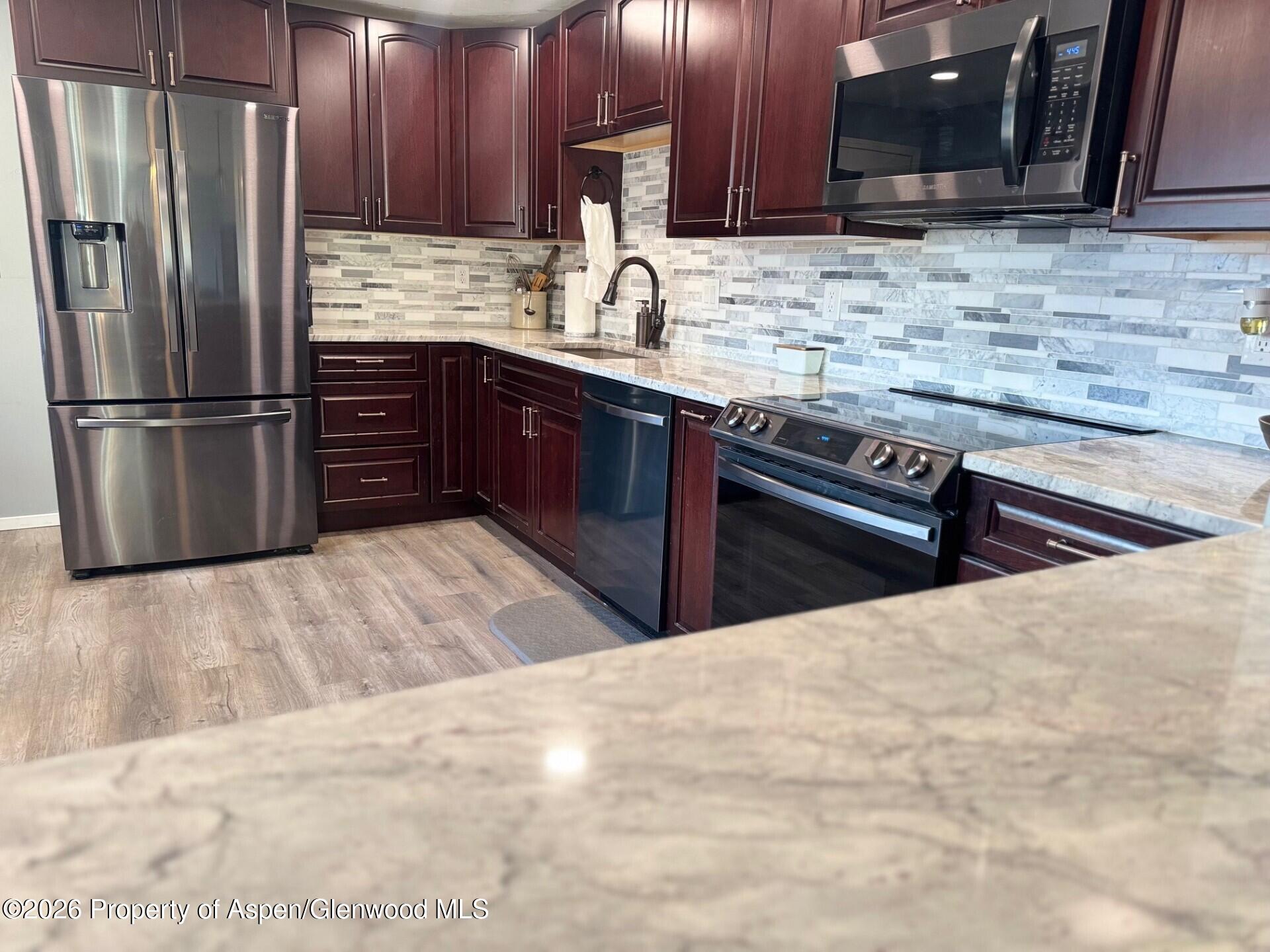 495 East 11th Street Craig, CO 81625 - Photo 3 of 12 a kitchen with stainless steel appliances granite countertop a sink stove and refrigerator