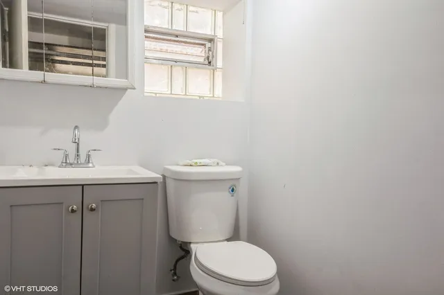a white toilet sitting next to a bathroom sink