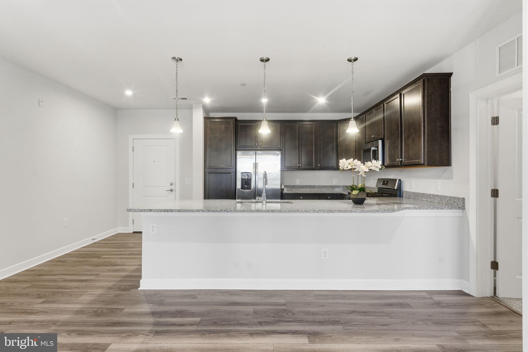3925 Fair Ridge Drive, Unit 304 Fairfax, VA 22033 - Photo 11 of 44 a view of a kitchen with a sink stainless steel appliances and cabinets