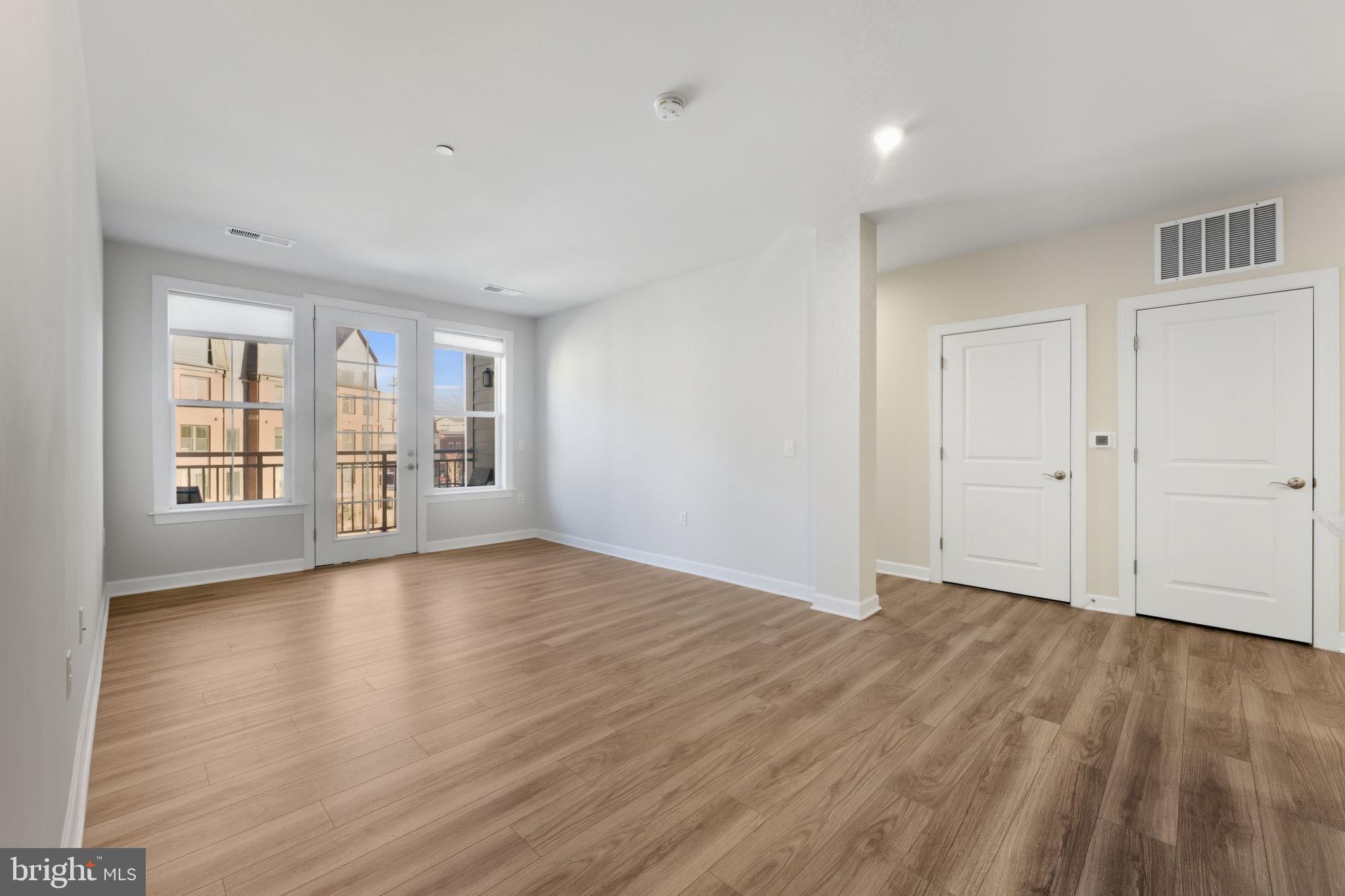 3925 Fair Ridge Drive, Unit 304 Fairfax, VA 22033 - Photo 14 of 44 a view of an empty room with wooden floor and a window
