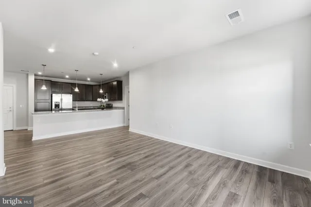 a view of kitchen and kitchen with furniture wooden floor and window