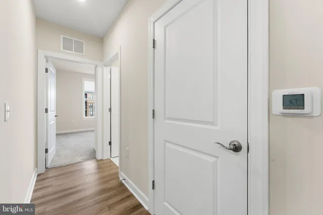 a view of a hallway with wooden floor