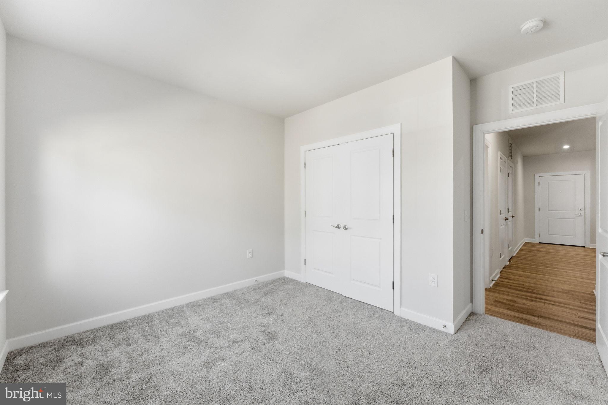 3925 Fair Ridge Drive, Unit 304 Fairfax, VA 22033 - Photo 19 of 44 a view of hallway with closet and wooden floor
