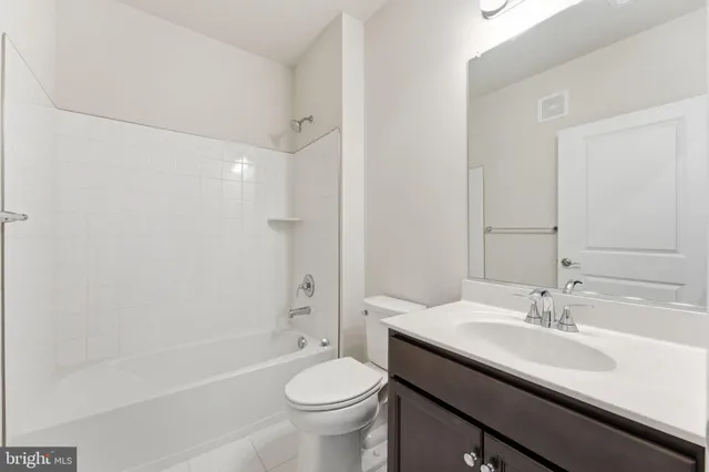a bathroom with a sink a toilet and a bathtub