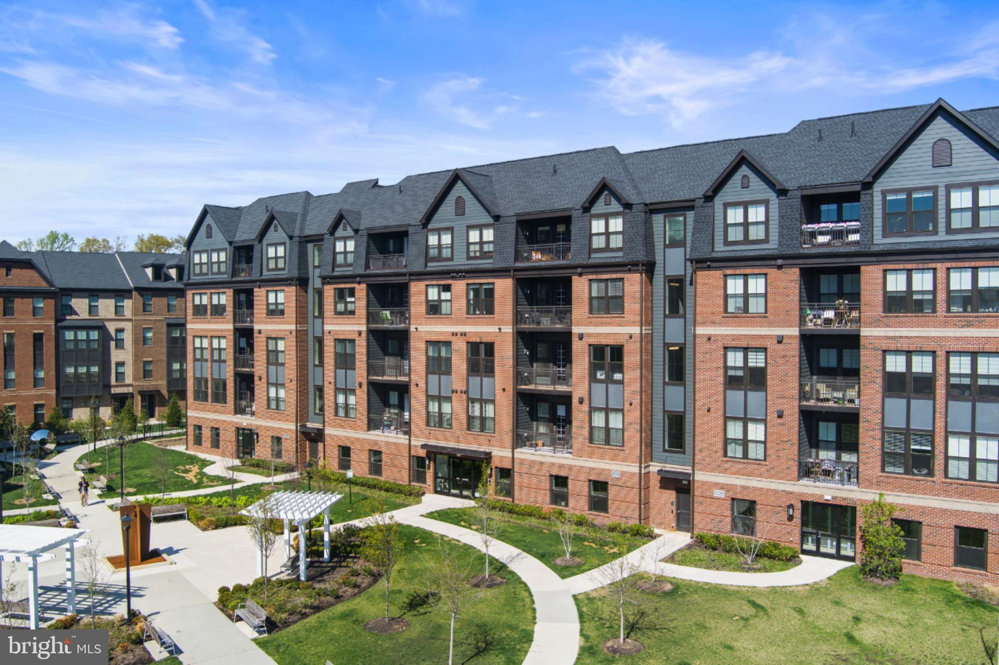 3925 Fair Ridge Drive, Unit 304 Fairfax, VA 22033 - Photo 39 of 44 a front view of a residential apartment building with a yard