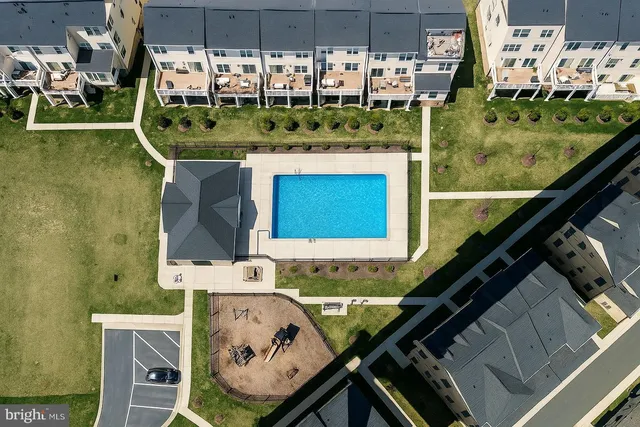 a view of a house with a yard and potted plants