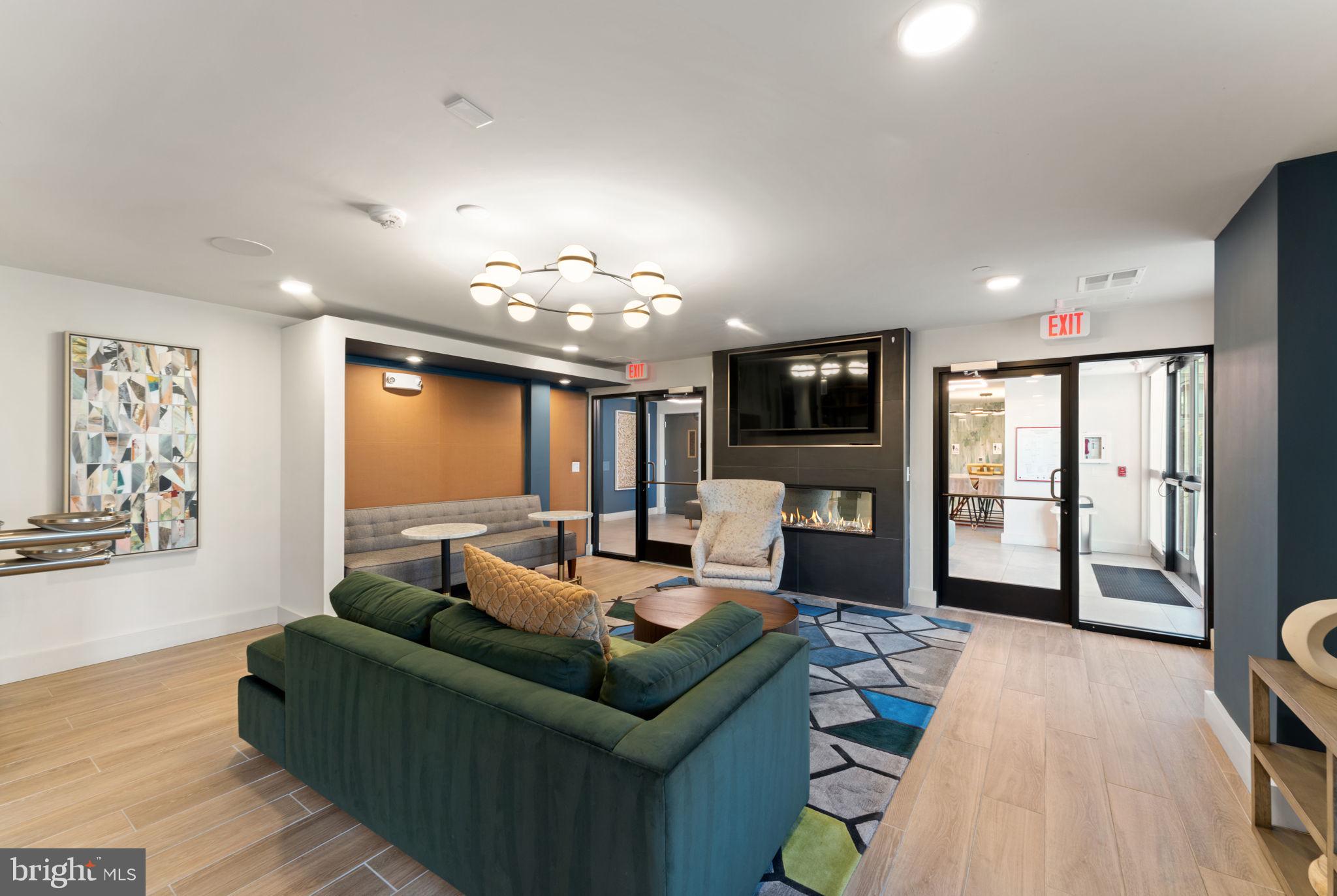 3925 Fair Ridge Drive, Unit 304 Fairfax, VA 22033 - Photo 44 of 44 a living room with furniture and a flat screen tv