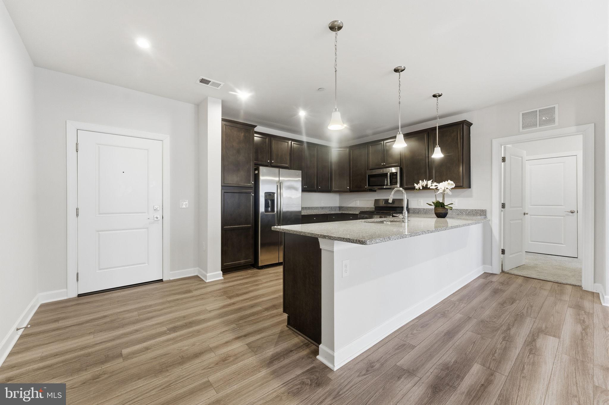 3925 Fair Ridge Drive, Unit 304 Fairfax, VA 22033 - Photo 6 of 44 a view of kitchen with refrigerator microwave and stove