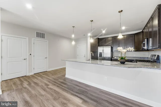 a view of kitchen with sink microwave and cabinets
