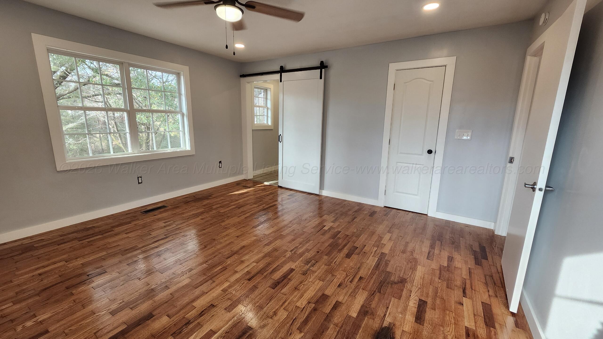 275 Robinson Loop Jasper, AL 35504 - Photo 17 of 25 Master bedroom. Barn door goes into Bath, other door to walk-in closet