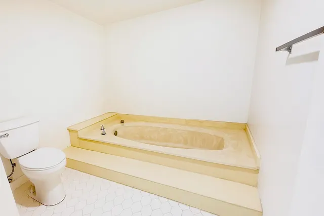a bathroom with a bathtub and toilet
