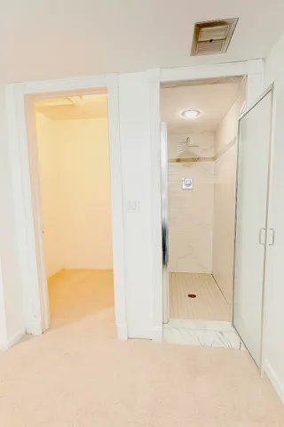 a bathroom with a glass shower door