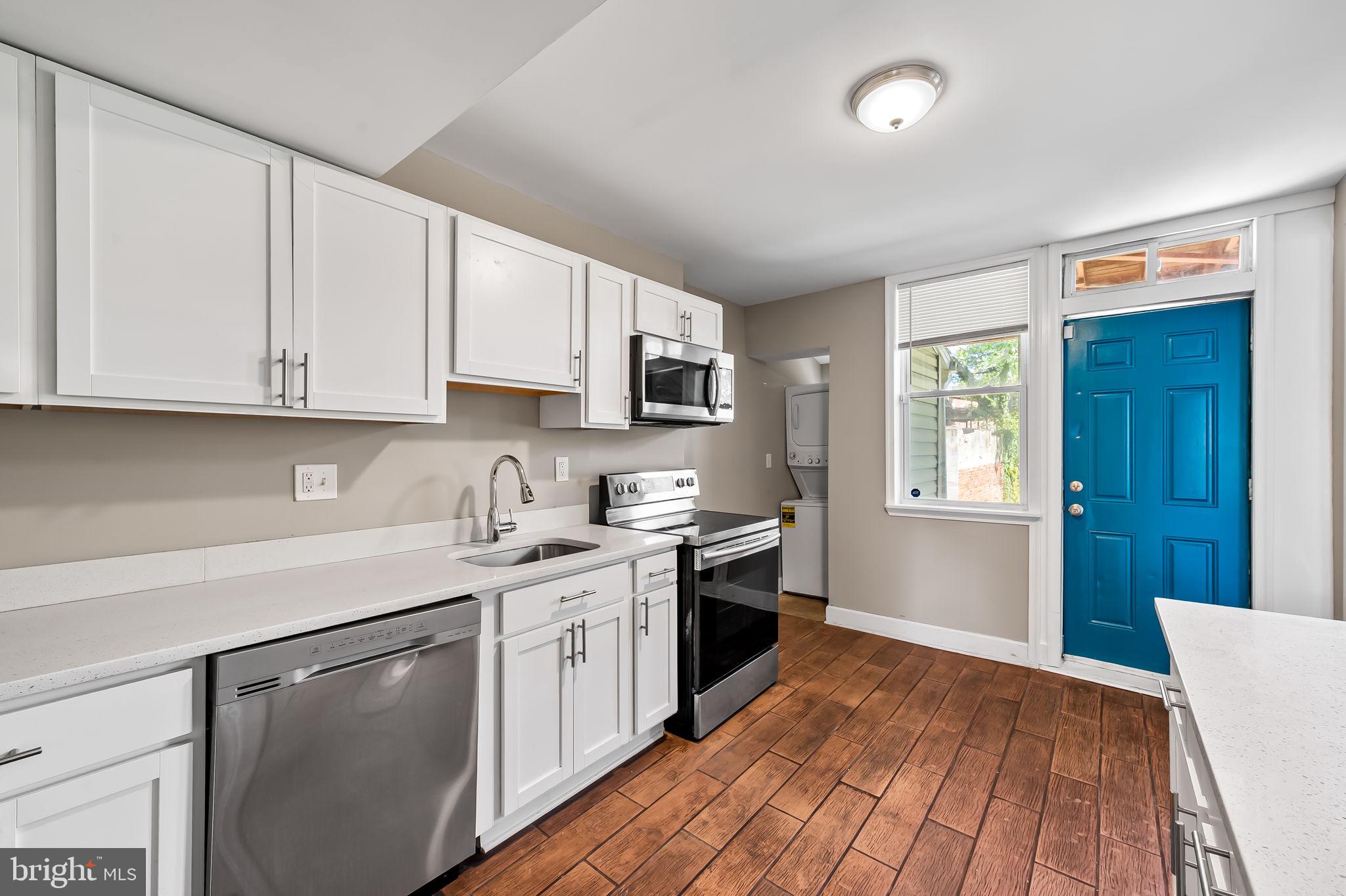 4021 Park Heights Avenue Baltimore, MD 21215 - Photo 11 of 32 a kitchen with stainless steel appliances granite countertop a sink stove and cabinets