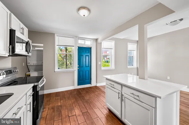 a kitchen with a sink stove and cabinets