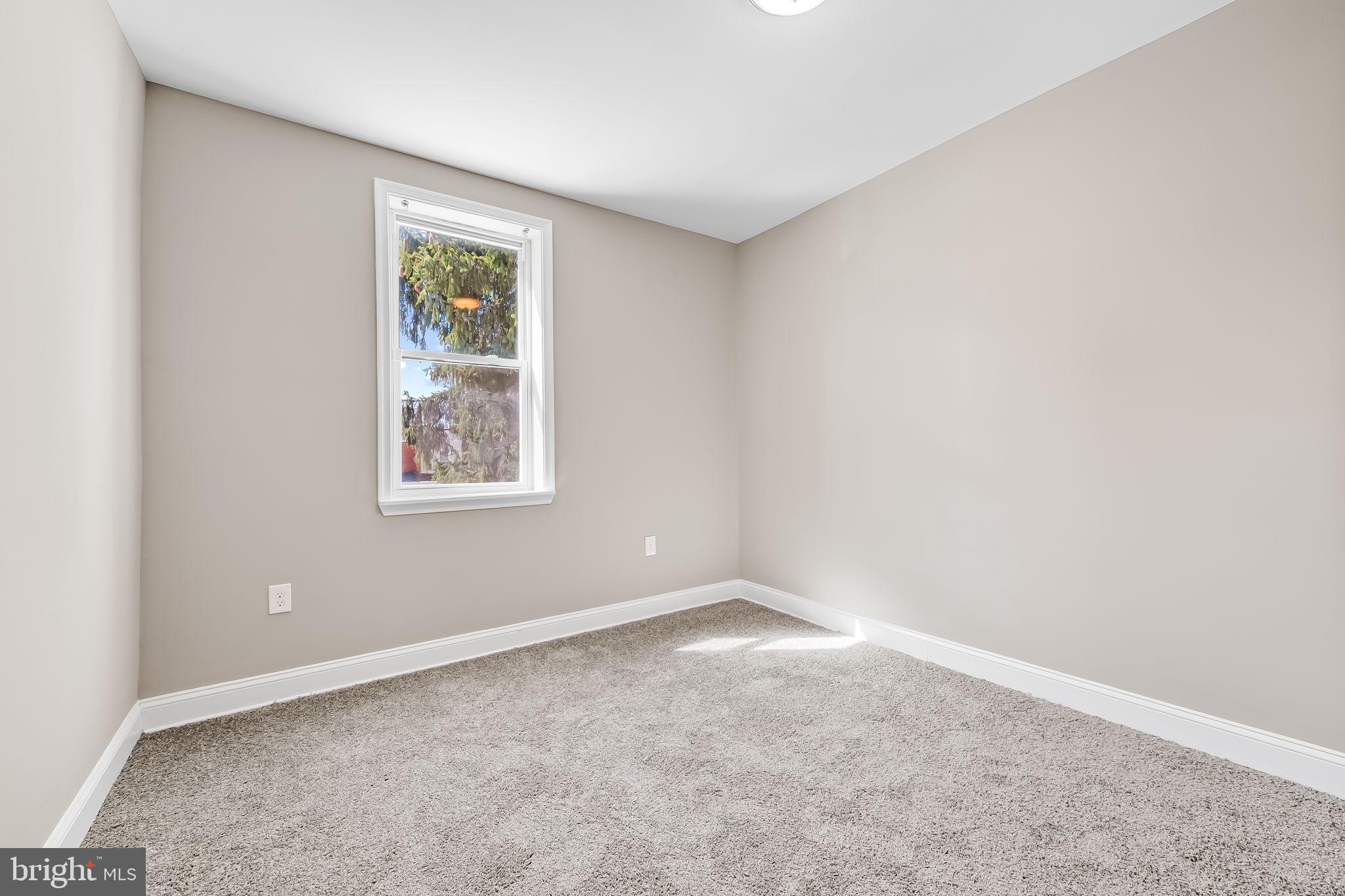4021 Park Heights Avenue Baltimore, MD 21215 - Photo 16 of 32 an empty room with windows